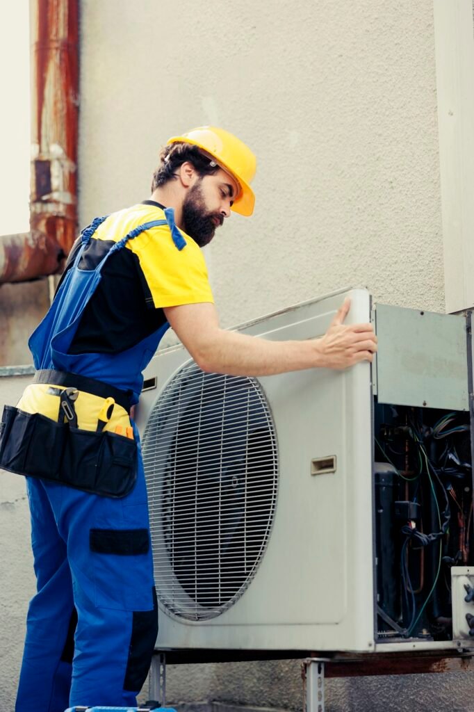 Technician fixing air conditioner